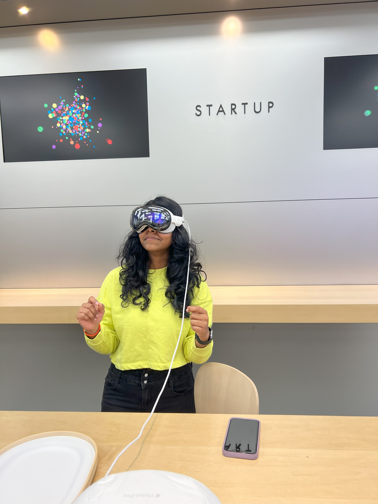 Jayasri wearing a headset in a startup space